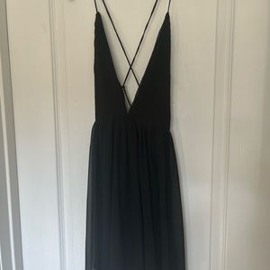 Black dress. Shorter than most dresses. Open back with straps along the back